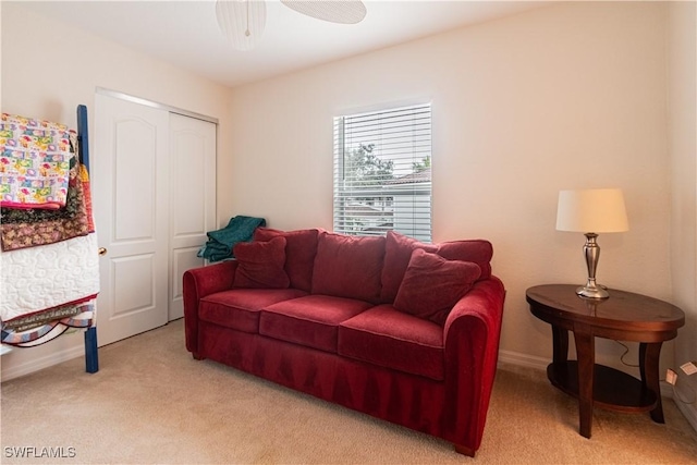 carpeted living room featuring ceiling fan