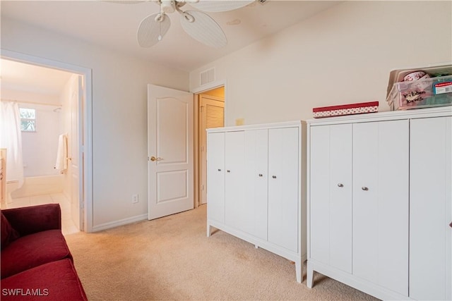 sitting room with ceiling fan and light colored carpet