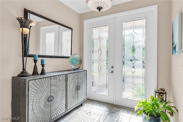 foyer entrance featuring french doors, light tile patterned flooring, and ornamental molding