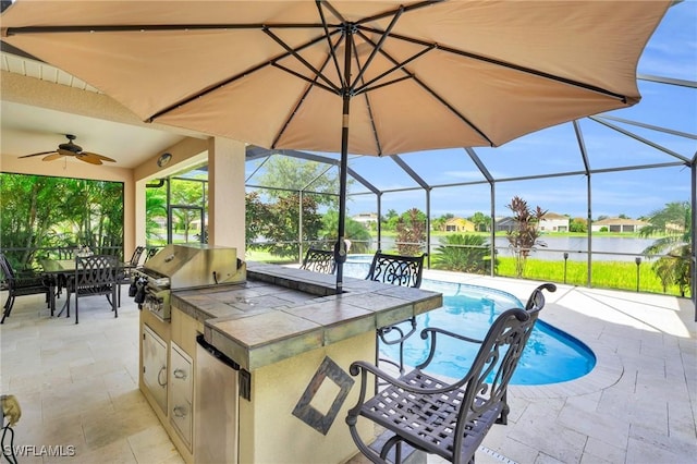 view of patio featuring exterior kitchen, a grill, exterior bar, ceiling fan, and a lanai