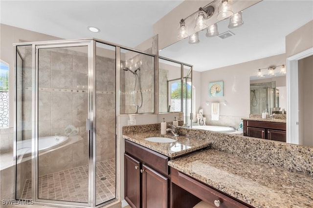 bathroom with vanity and independent shower and bath