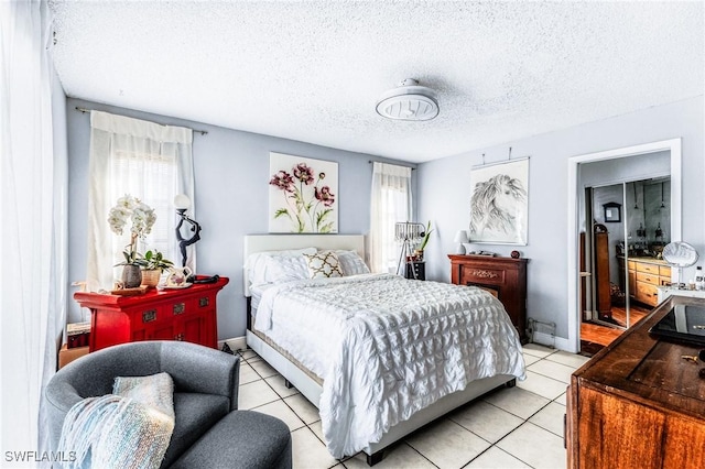 bedroom with light tile patterned flooring and a textured ceiling