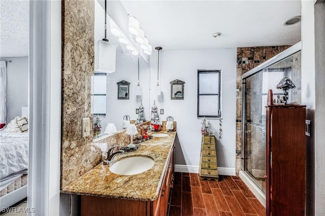 bathroom featuring vanity and a shower with shower door