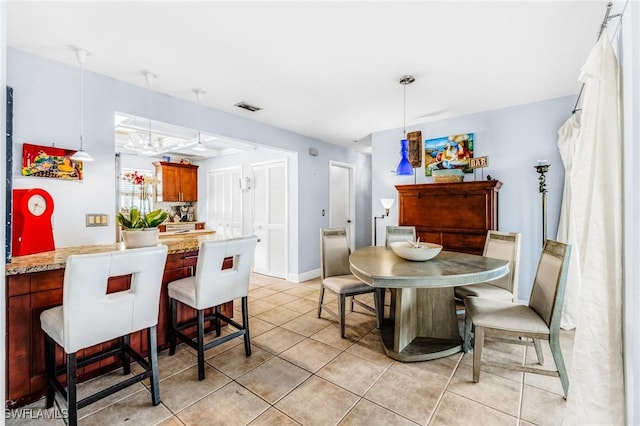 dining space featuring light tile patterned floors