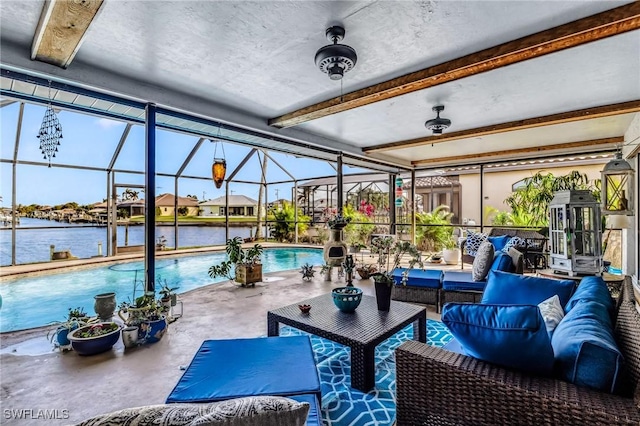 sunroom / solarium with a water view, a healthy amount of sunlight, and beam ceiling