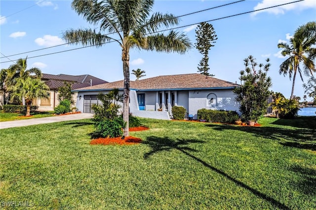 ranch-style house with a garage and a front lawn