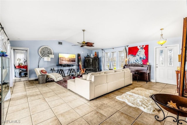 tiled living room with vaulted ceiling and ceiling fan