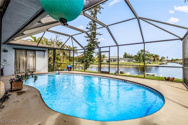 view of pool with a lanai, a patio, and a water view