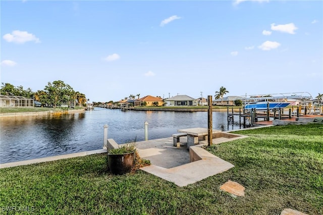 view of dock featuring a water view and a yard