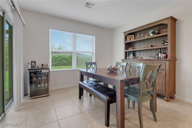 dining room with wine cooler and light tile patterned floors