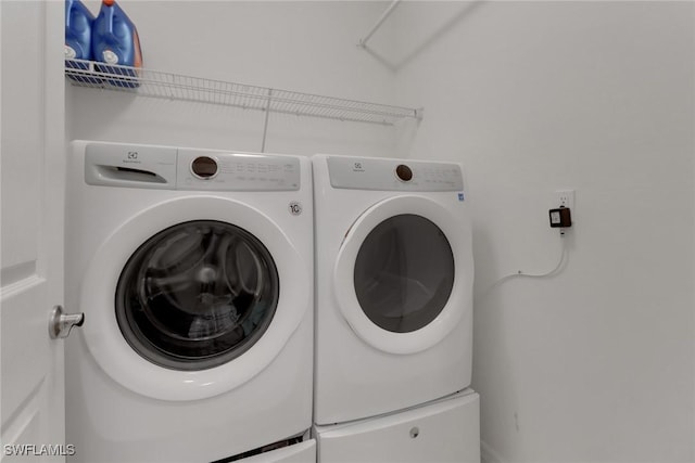 laundry area with separate washer and dryer