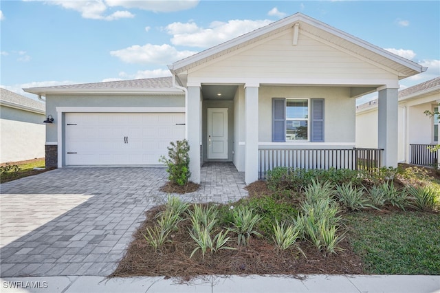 view of front of home with a porch and a garage