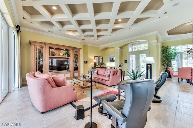 tiled living room with ornate columns, coffered ceiling, french doors, crown molding, and beam ceiling