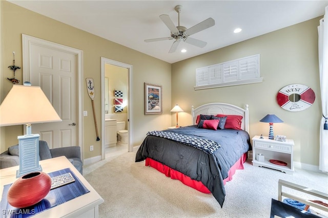 bedroom with ceiling fan, ensuite bathroom, and light colored carpet