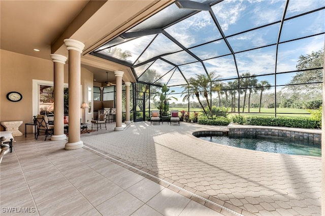 view of swimming pool with a lanai, ceiling fan, and a patio area