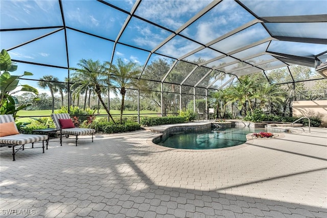 view of swimming pool with a lanai, a patio area, and a hot tub