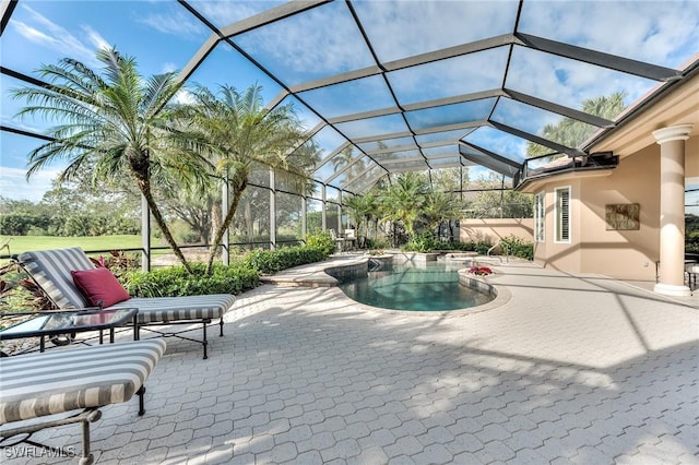 view of pool with a lanai and a patio