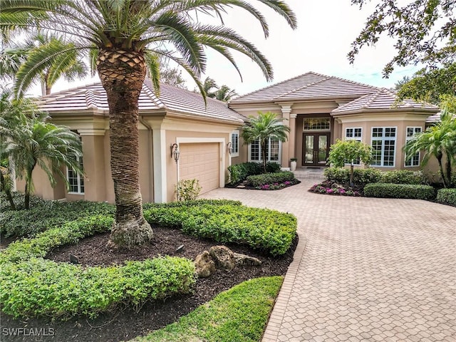 view of front facade with a garage and french doors