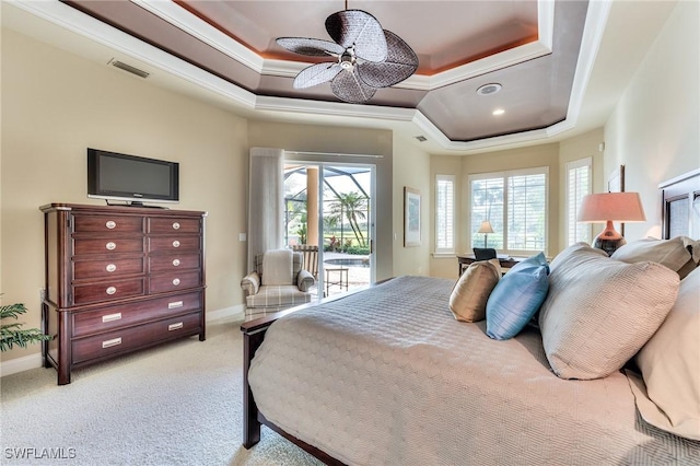 bedroom featuring ceiling fan, light colored carpet, a raised ceiling, access to outside, and ornamental molding