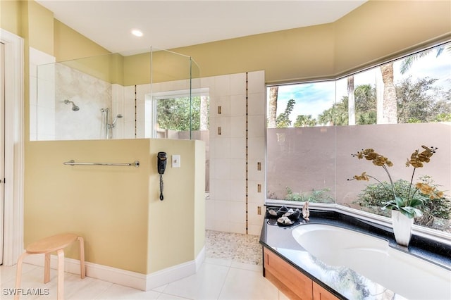 bathroom with independent shower and bath and tile patterned floors