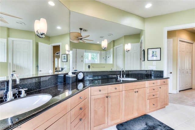 bathroom with ceiling fan, vanity, tile patterned flooring, and a shower with door