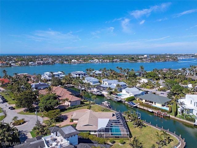 aerial view of residential area featuring a nearby body of water