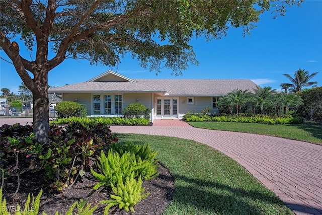 view of front facade featuring a front yard and french doors