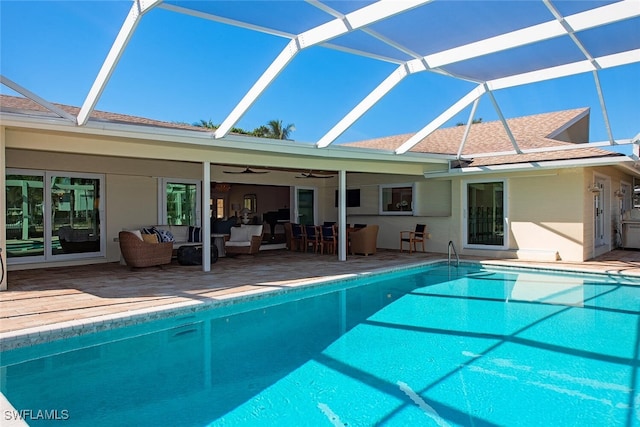 view of swimming pool featuring an outdoor living space, a lanai, a patio, and ceiling fan