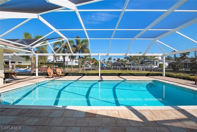 view of pool with a patio and glass enclosure