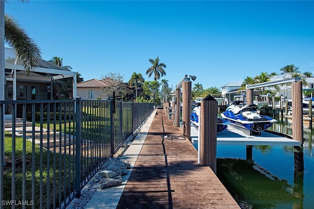 view of dock featuring a water view and glass enclosure