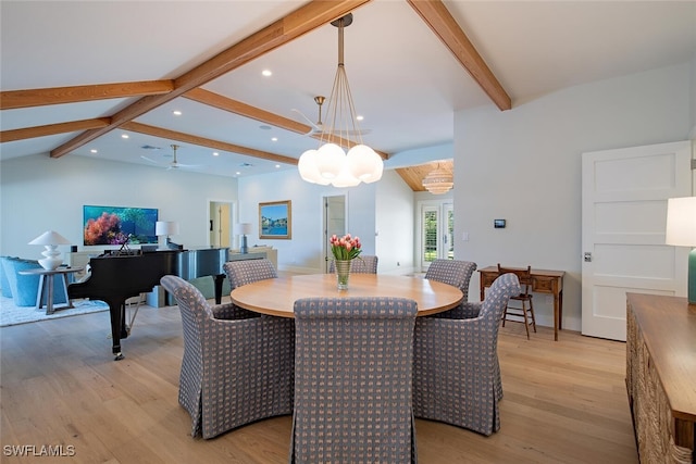 dining area featuring an inviting chandelier, vaulted ceiling with beams, and light hardwood / wood-style floors