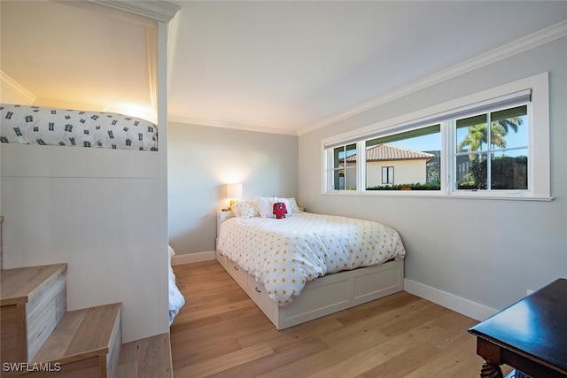 bedroom featuring ornamental molding and light hardwood / wood-style flooring