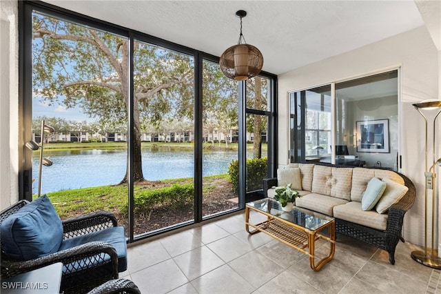 sunroom / solarium featuring a water view