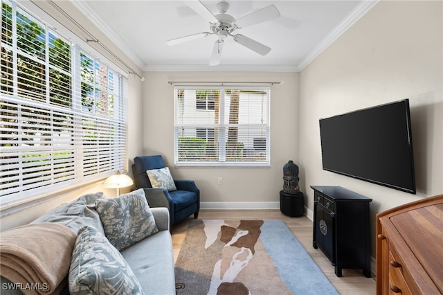 living room with ceiling fan, ornamental molding, and light hardwood / wood-style flooring