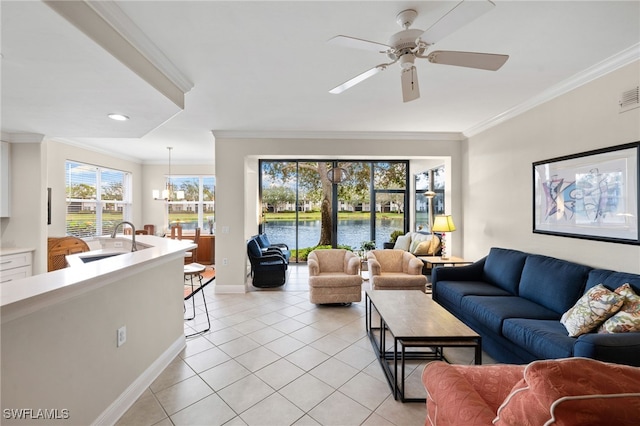 tiled living room featuring ceiling fan with notable chandelier, crown molding, a water view, and sink