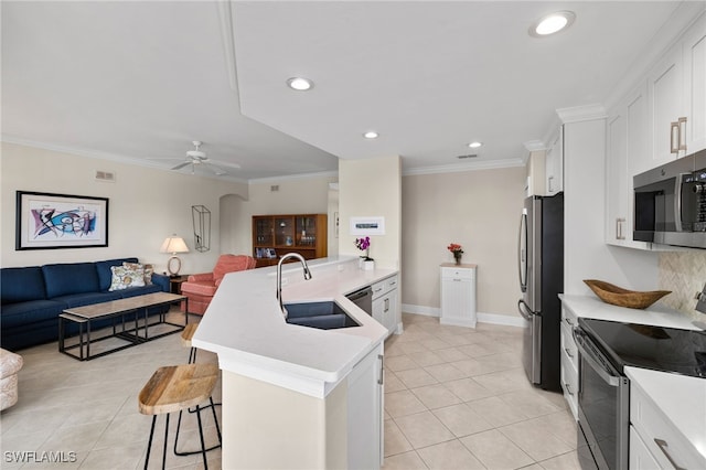 kitchen featuring stainless steel appliances, white cabinetry, and sink