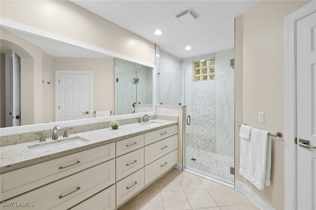 bathroom featuring vanity, tile patterned flooring, and walk in shower