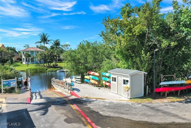 exterior space featuring a water view and a shed