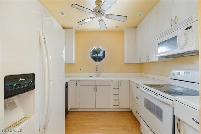 kitchen with light wood-type flooring, white cabinetry, sink, and white appliances