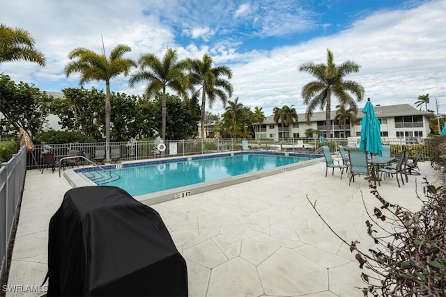 view of pool featuring grilling area and a patio area