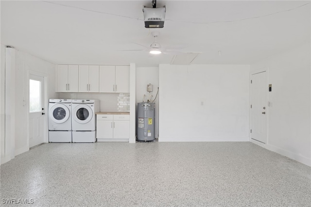 garage with separate washer and dryer, electric water heater, and a garage door opener