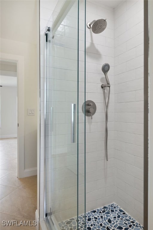 bathroom with tile patterned floors and an enclosed shower