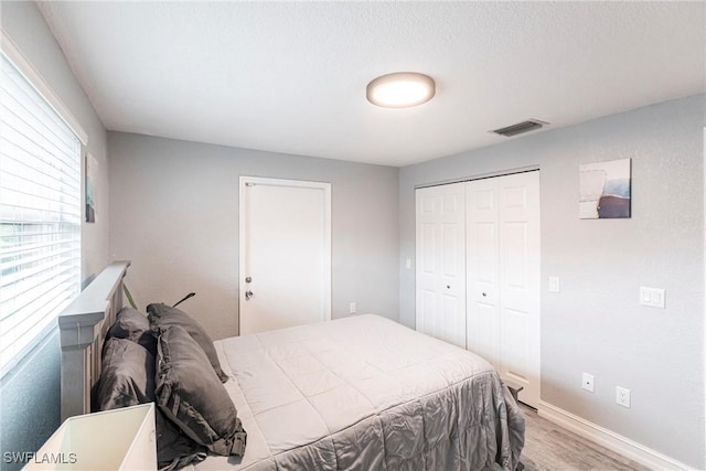 bedroom featuring light hardwood / wood-style flooring and a closet