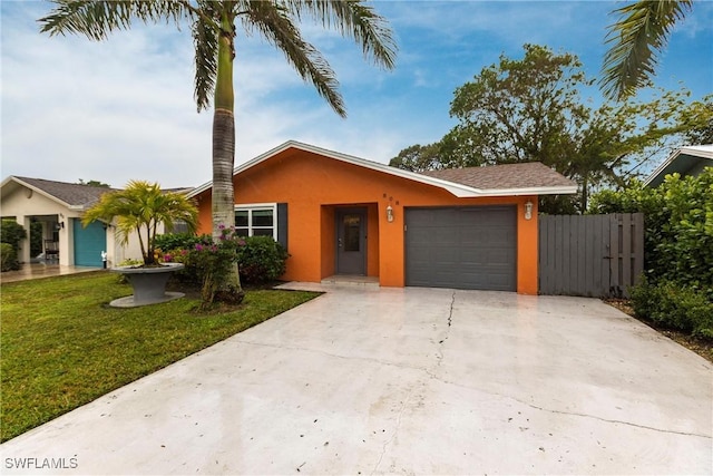 single story home featuring a garage and a front yard