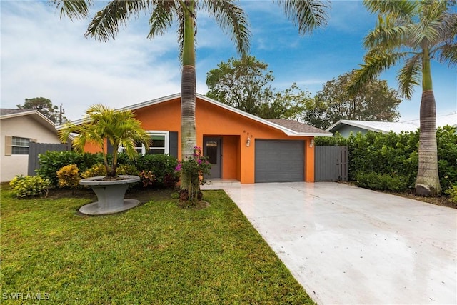 ranch-style house featuring a garage and a front yard