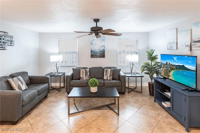 tiled living room featuring ceiling fan, a wealth of natural light, and a textured ceiling