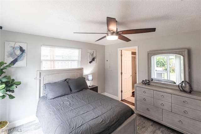 bedroom featuring a textured ceiling, ceiling fan, and light hardwood / wood-style flooring