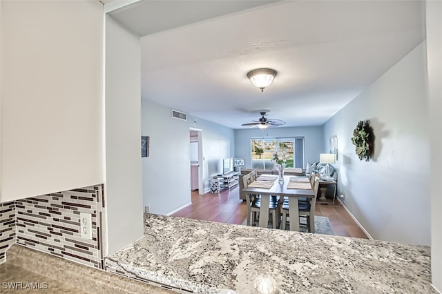 dining area with ceiling fan and dark hardwood / wood-style flooring