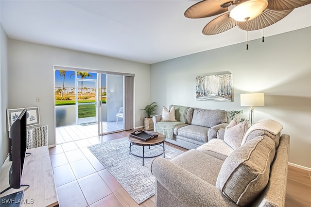 tiled living room with ceiling fan