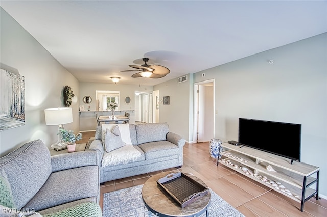 living room featuring ceiling fan and light tile patterned flooring